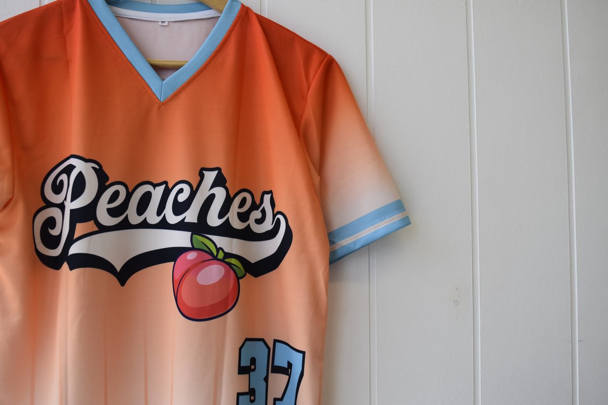 Peaches sublimated jersey by Melbourne Merch - peach orange ombre with sky blue trim, Peaches script lettering, peach motif, number 37