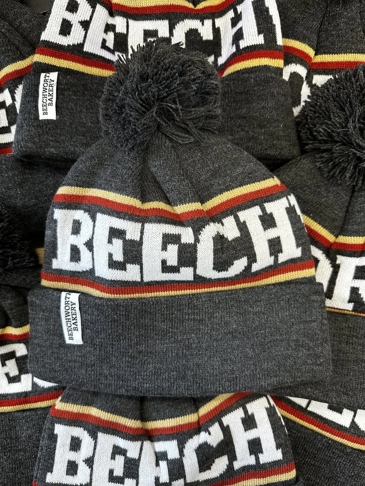Beechworth Bakery embroidered beanies stacked with crisp engraving