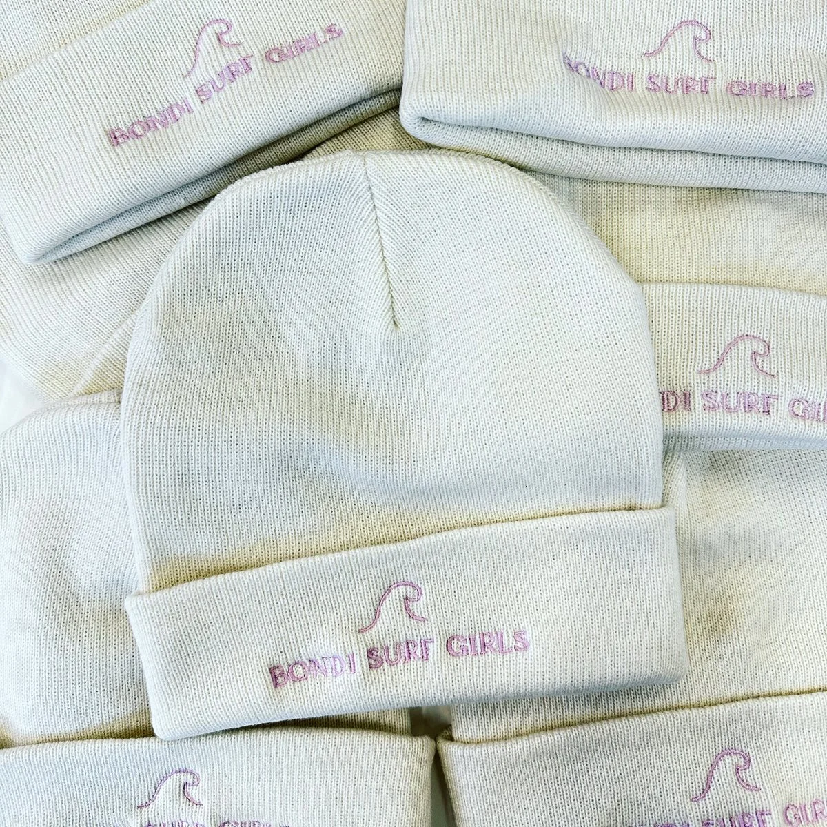 Bondi Surf Girls embroidered beanies cleanly stacked